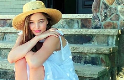 Miranda Kerr flaunts baby bump in festive dress