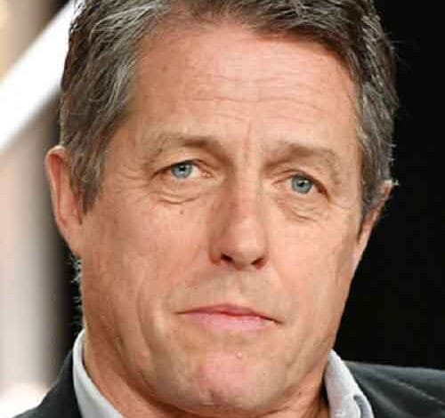 Hugh Grant helps serve Christmas meal to 500 elderly residents in London