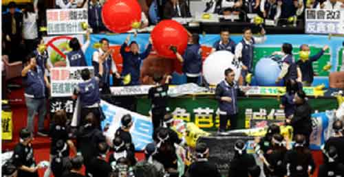 Taiwan’s opposition-led Parliament amends law to expand power